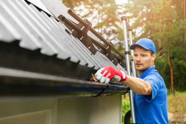 a professional is Inspect and cleaning roof drain gutter