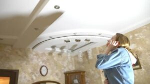 a women doing roof inspection from inside the home